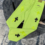 Lime green pants with black and yellow cross appliques across the front legs