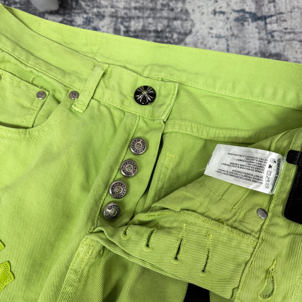 Neon lime green pants with button closures and inner care label near waistband