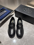 Black leather loafers with Prada triangular logo, slip-on style