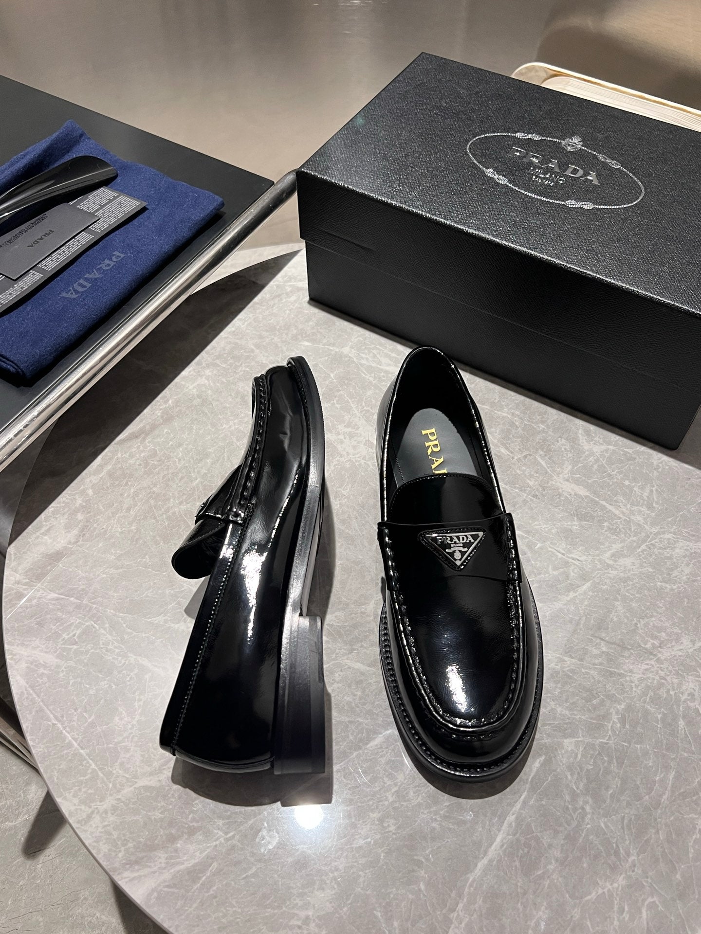 Prada unisex black patent loafers with chunky outsole, heel side view
