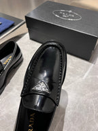 Prada unisex black patent loafer close-up of strap and insole branding