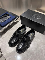 Prada unisex black patent loafers with leather strap and logo