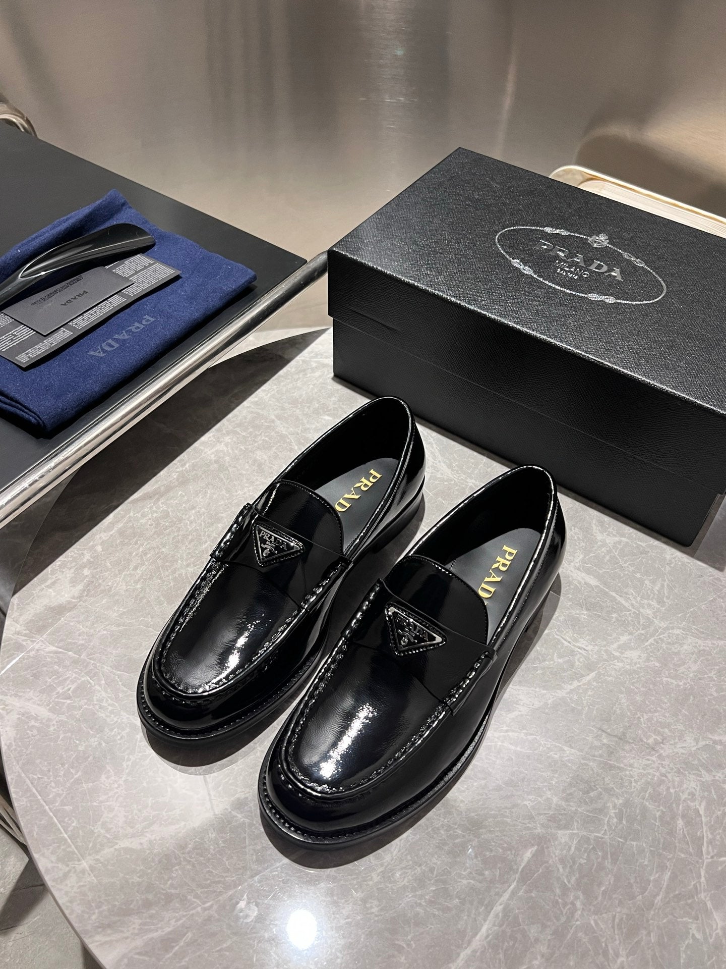Prada unisex black patent loafers with leather strap and logo