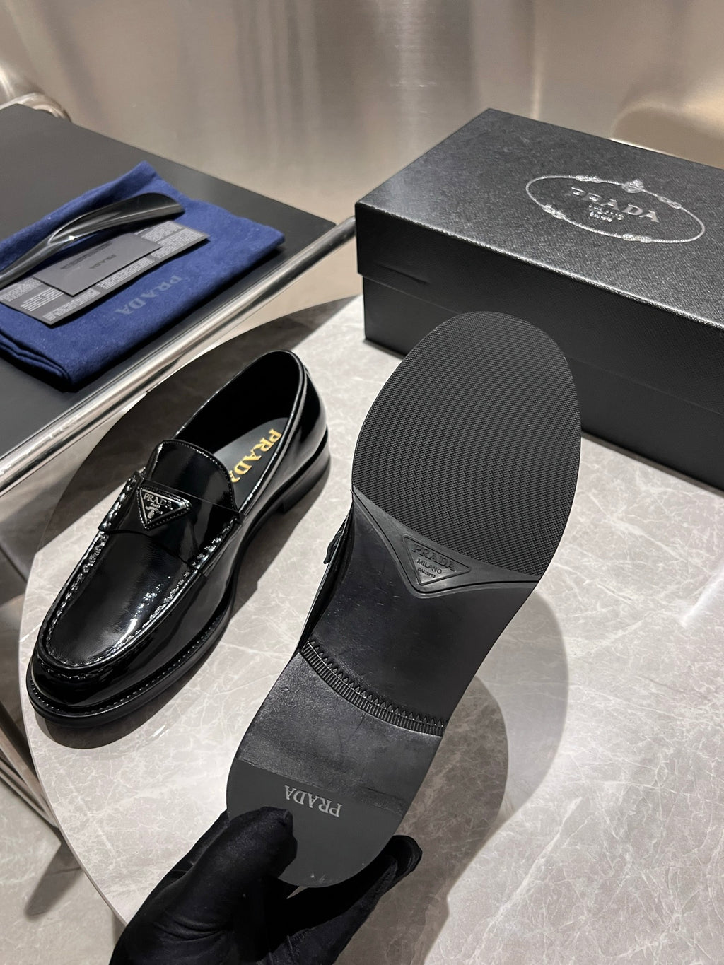 Prada unisex black patent loafers with matching insert labeled Prada