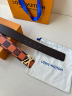 Louis Vuitton belt showing buckle and hole row on dark strap with orange pattern.