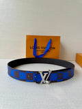 Louis Vuitton belt with blue check strap and gold-tone LV buckle on dark base.