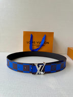 Louis Vuitton belt with blue check strap and gold-tone LV buckle on dark base.