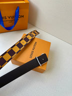 Check-pattern belt lying with dark strap and large LV logo buckle