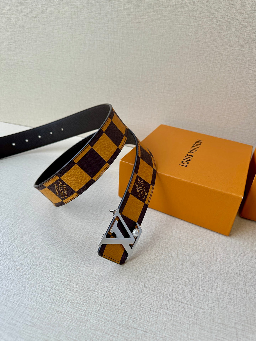 Check-pattern belt with silver-tone LV buckle and dark leather strap