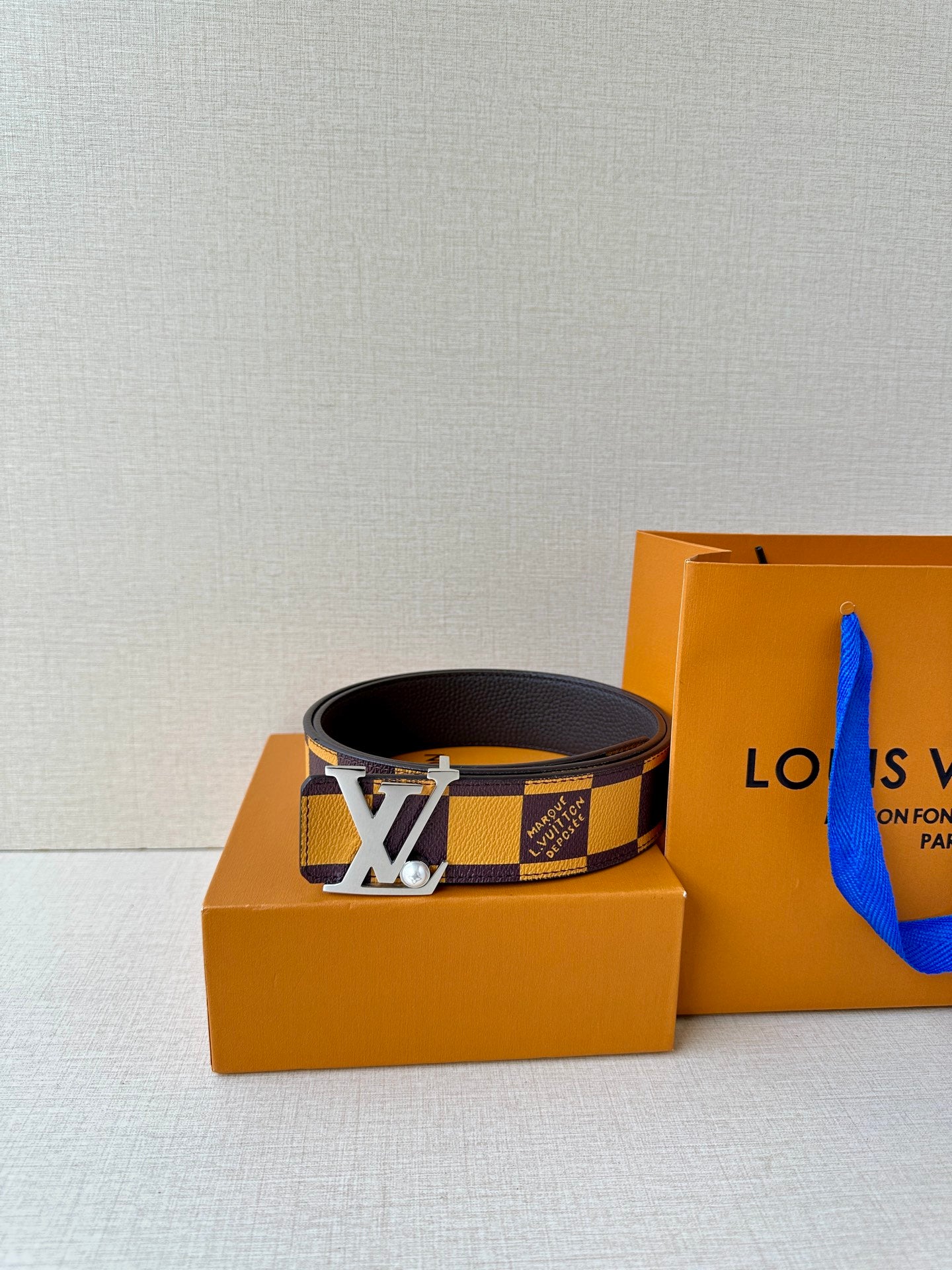 Check-pattern leather belt with gold-tone LV logo buckle and dark strap