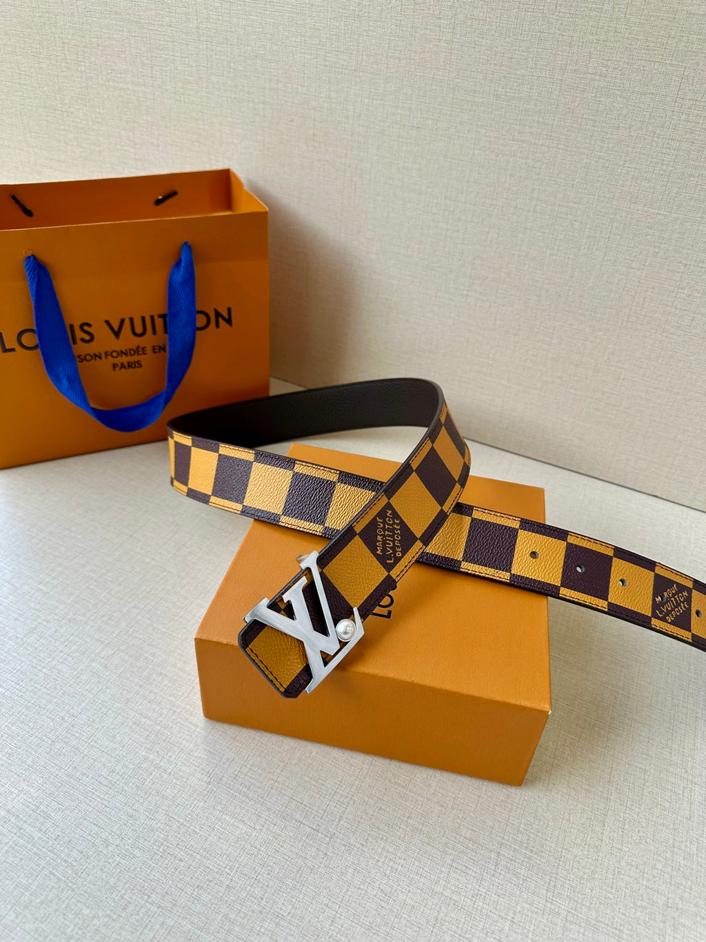 Check-pattern leather belt with dark strap and silver-tone LV logo buckle