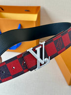 Louis Vuitton belt close-up: red-and-black check strap with silver LV buckle