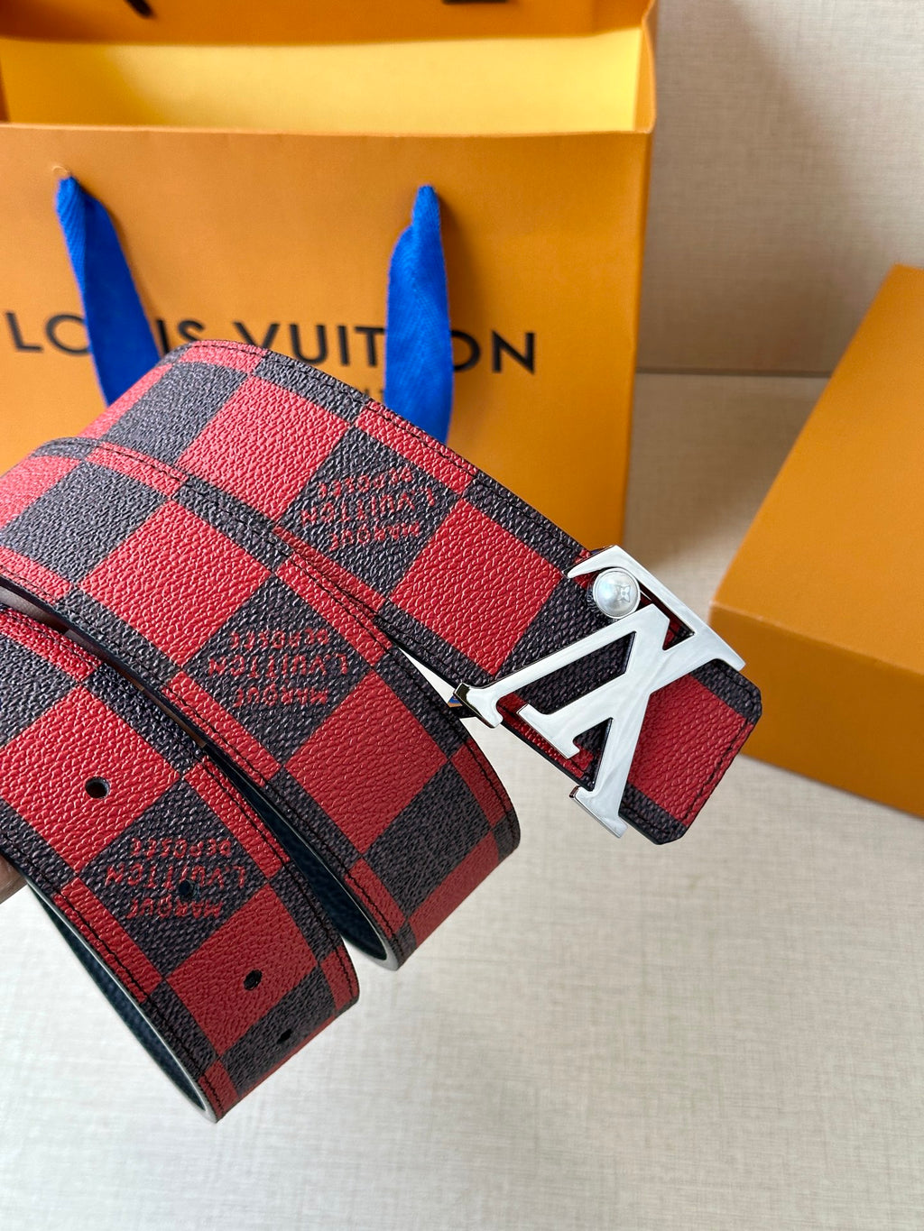 Louis Vuitton belt end and buckle: red-and-black check strap with silver clasp
