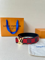 Louis Vuitton belt with red-and-black check pattern and silver LV buckle on dark strap