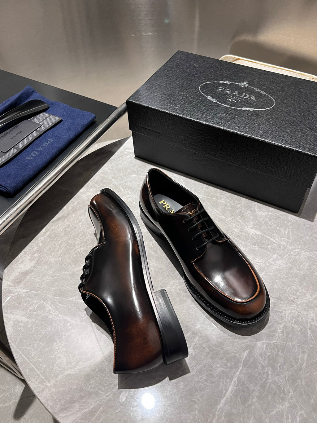 Brown leather lace-up shoes with black laces and platform-style soles