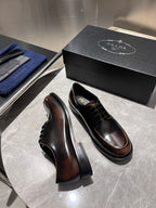 Brown leather lace-up shoes with black laces and platform-style soles