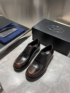 Black leather lace-up derby shoes with brown welt and padded collar