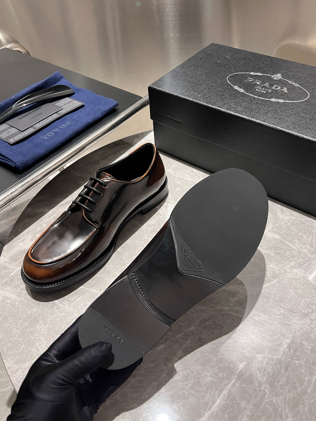 Leather lace-up shoes with black boot socks and black box lid backdrop