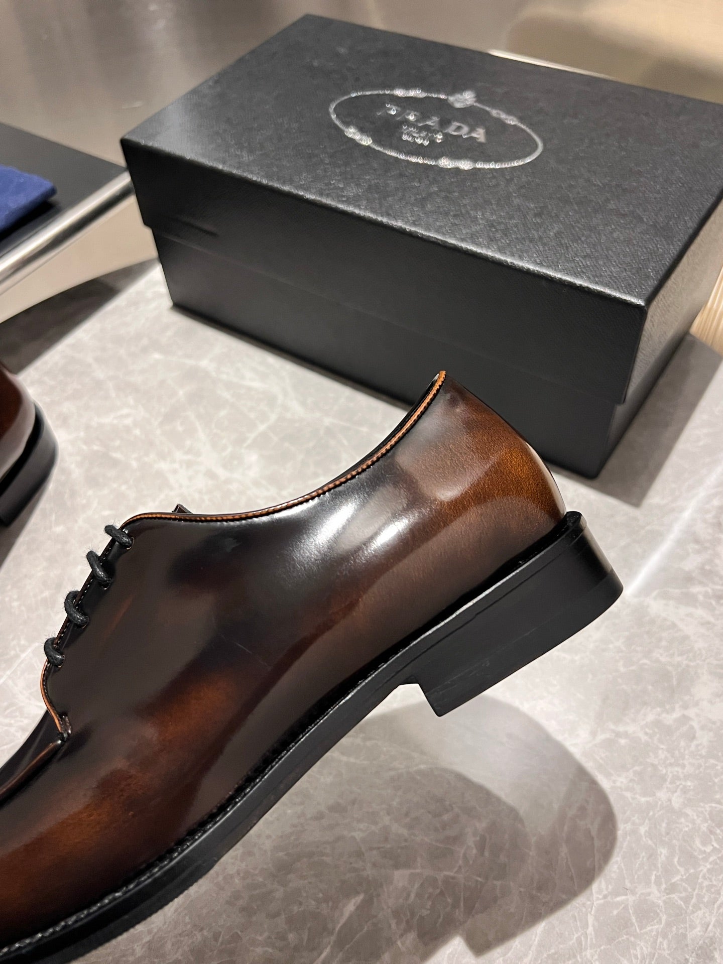 Brown leather lace-up oxford shoes with black outsole and stitched edge