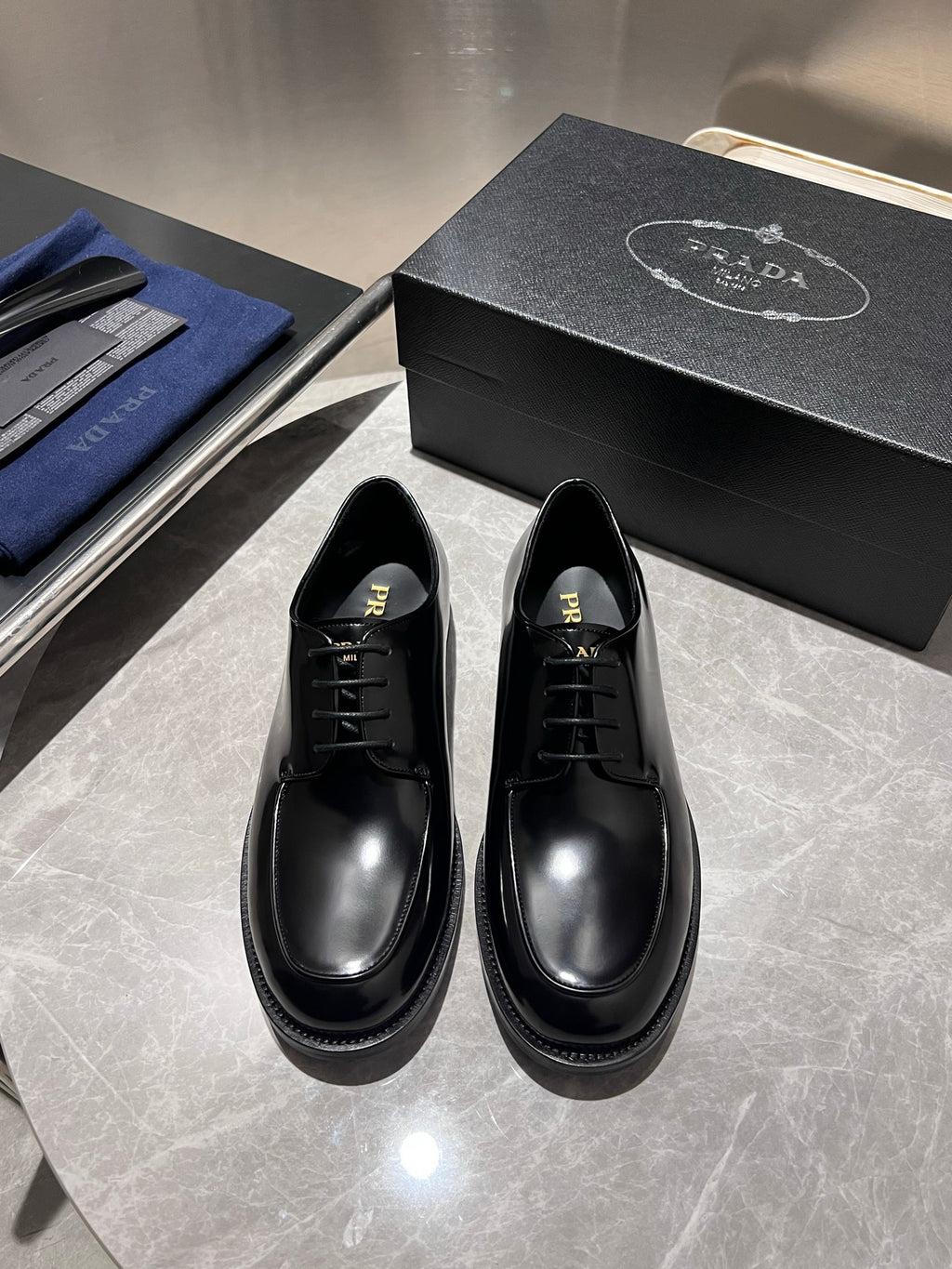Unisex black leather lace-up shoes with pointed toe and black laces; pair shown