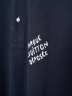 Navy polo shirt with embroidered script logo near the button placket