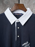 Navy polo with white spread collar, white buttons, and Louis Vuitton label.