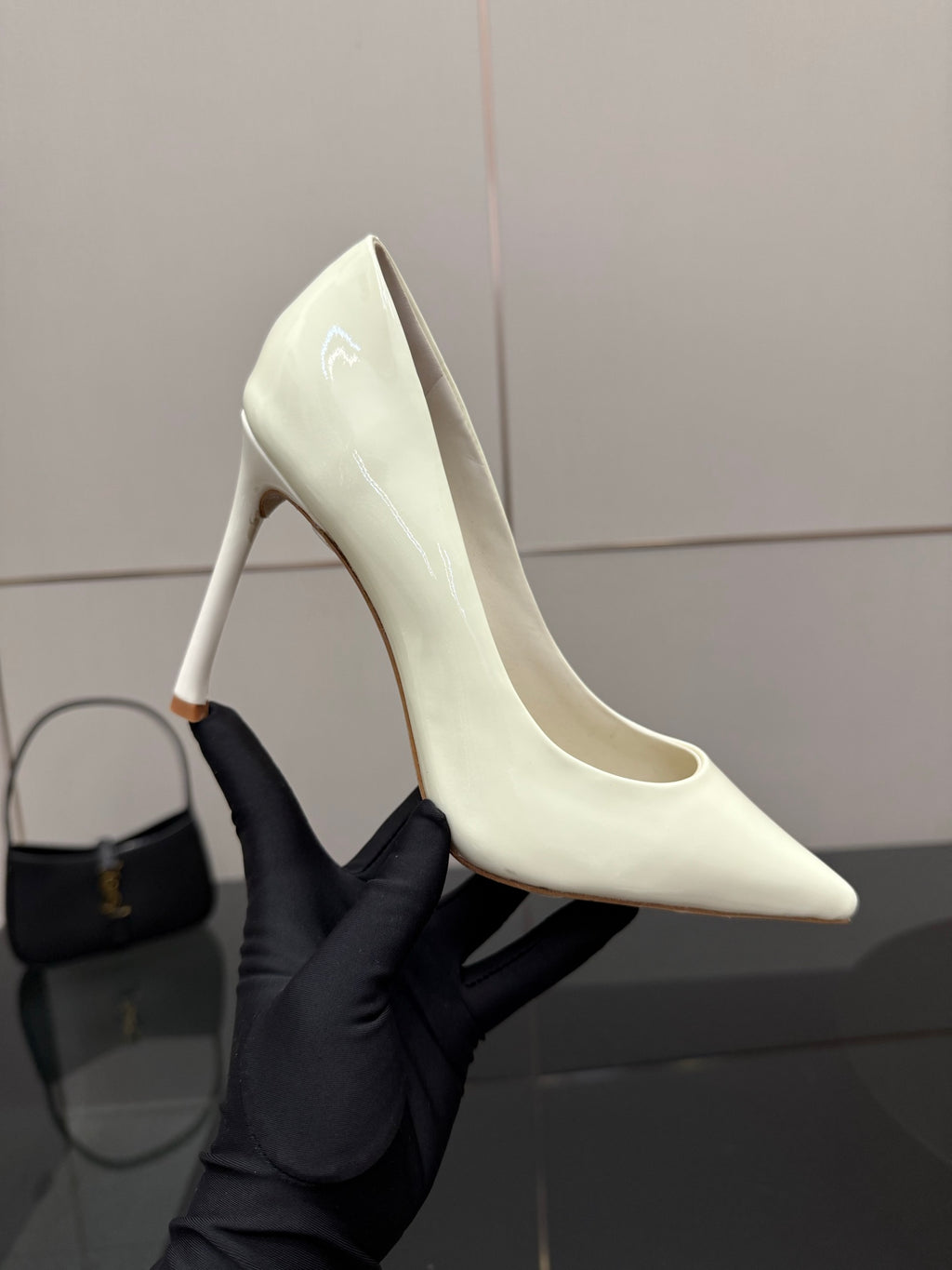 Dior women’s pointed-toe pump, light yellow, close-up of high stiletto heel