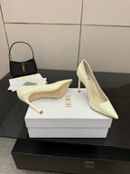 Dior women’s pointed-toe pumps, light yellow, one shoe profile with high stiletto heel