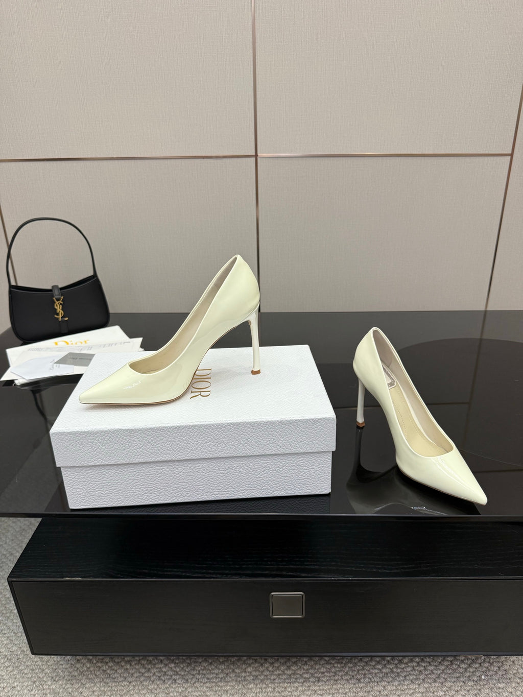 Dior women’s pointed-toe pumps, light yellow, two-shoe view with high stiletto heels