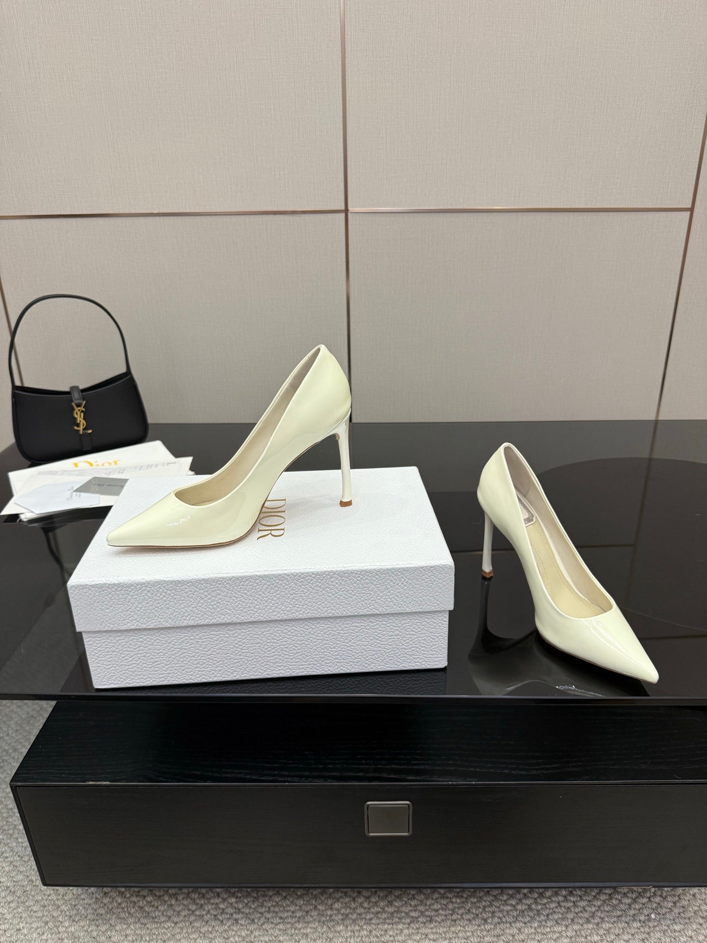 Dior women’s pointed-toe pumps, light yellow, two-shoe view with high stiletto heels