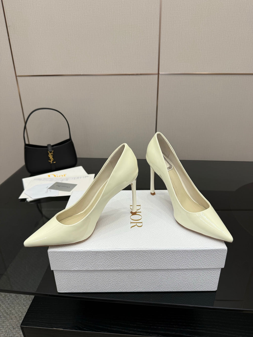 Dior women’s pointed-toe pumps, light yellow, angled view with high stiletto heel