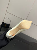 Dior women’s pointed-toe pump, light yellow, close-up view of insole and outsole edge