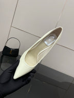 Dior women’s pointed-toe pump, light yellow, showing inner lining and insole