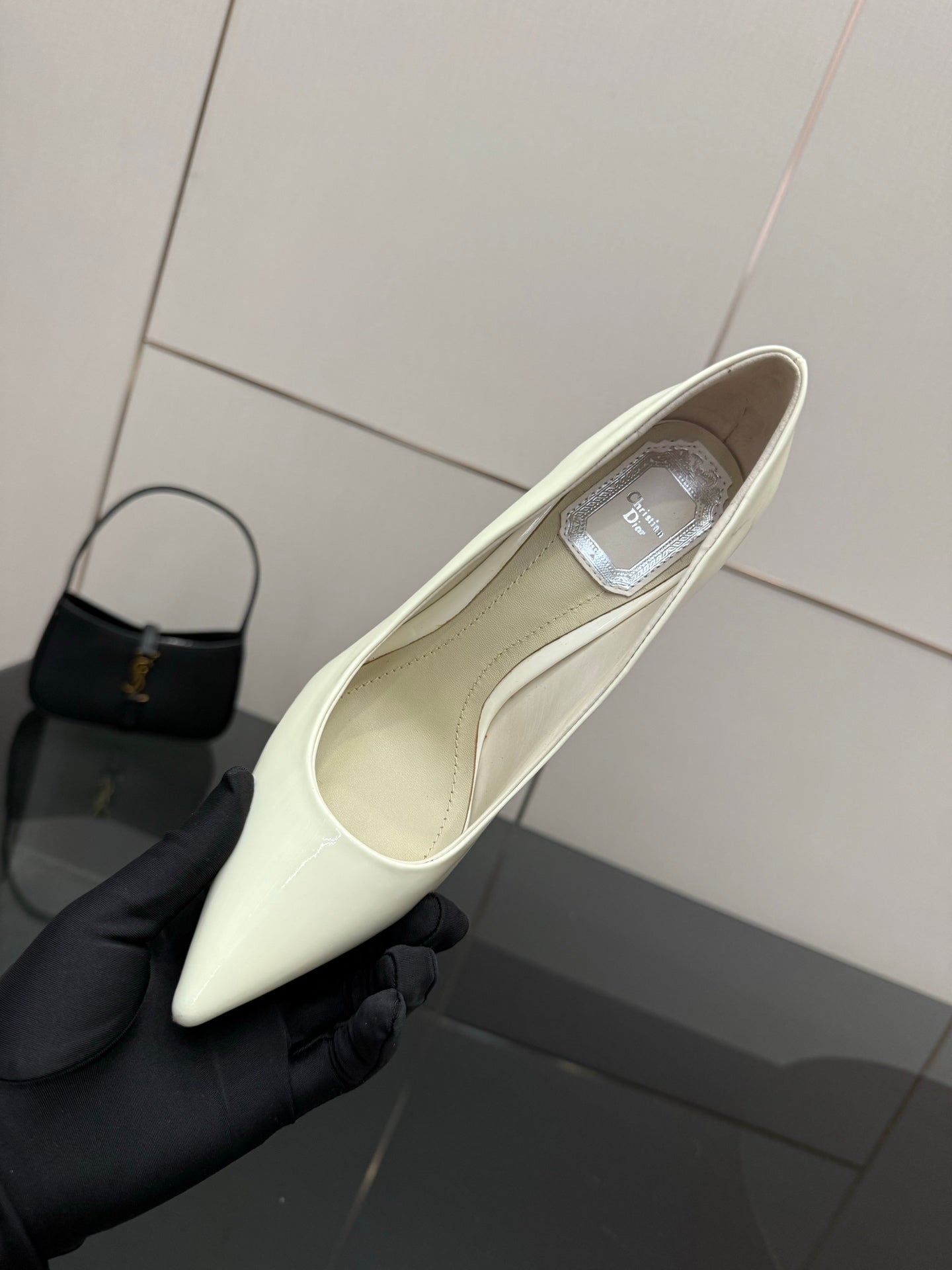 Dior women’s pointed-toe pump, light yellow, showing inner lining and insole