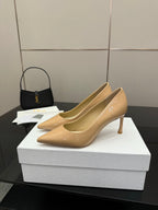 Beige patent pointed-toe pump with slender stiletto heel, side profile