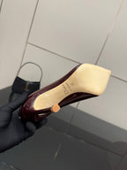 Burgundy patent leather stiletto pump showing heel interior padding