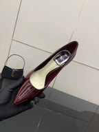Burgundy patent leather pointed-toe stiletto pump with cream interior lining