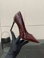 Burgundy patent leather pointed-toe stiletto pump, close-up of heel
