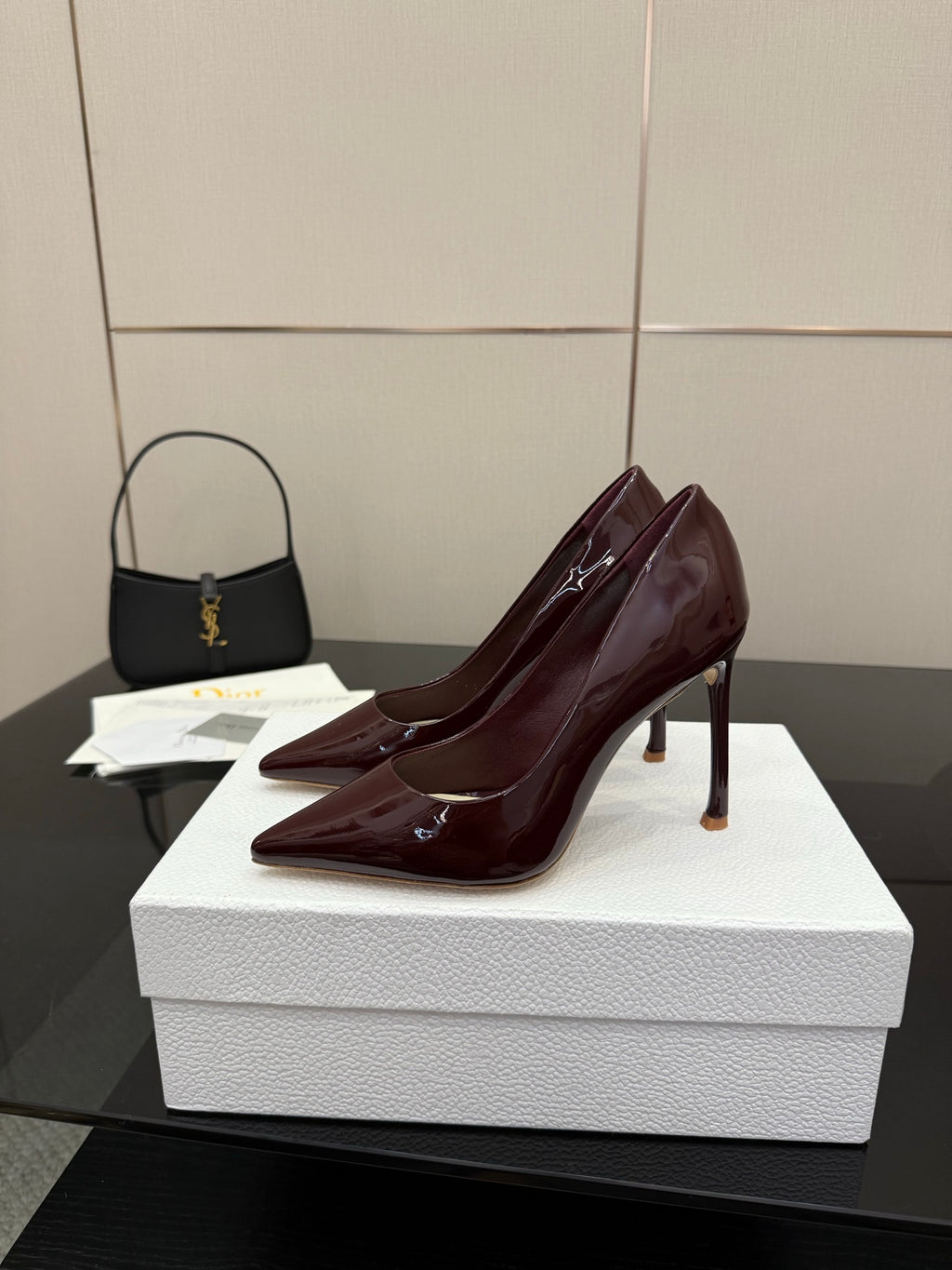 Burgundy patent leather pointed-toe stiletto pumps, angled side view