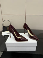 Burgundy patent leather pointed-toe stiletto pumps, side view