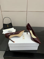 Burgundy patent leather pointed-toe stiletto pumps with light insole