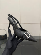 Black Dior slingback pump close-up, silver buckle strap, textured leather upper