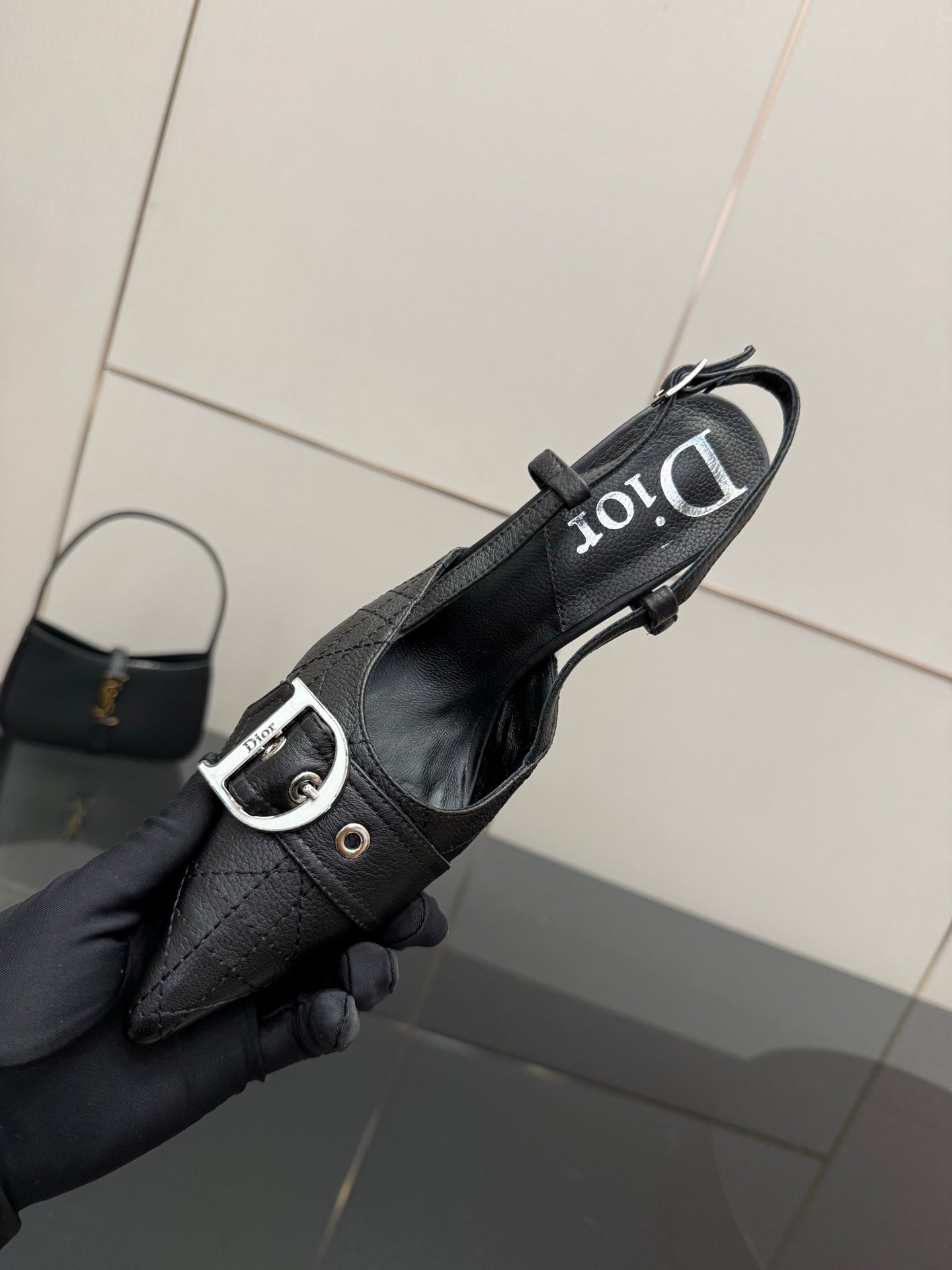 Black Dior slingback pump close-up, pointed toe, silver buckle strap