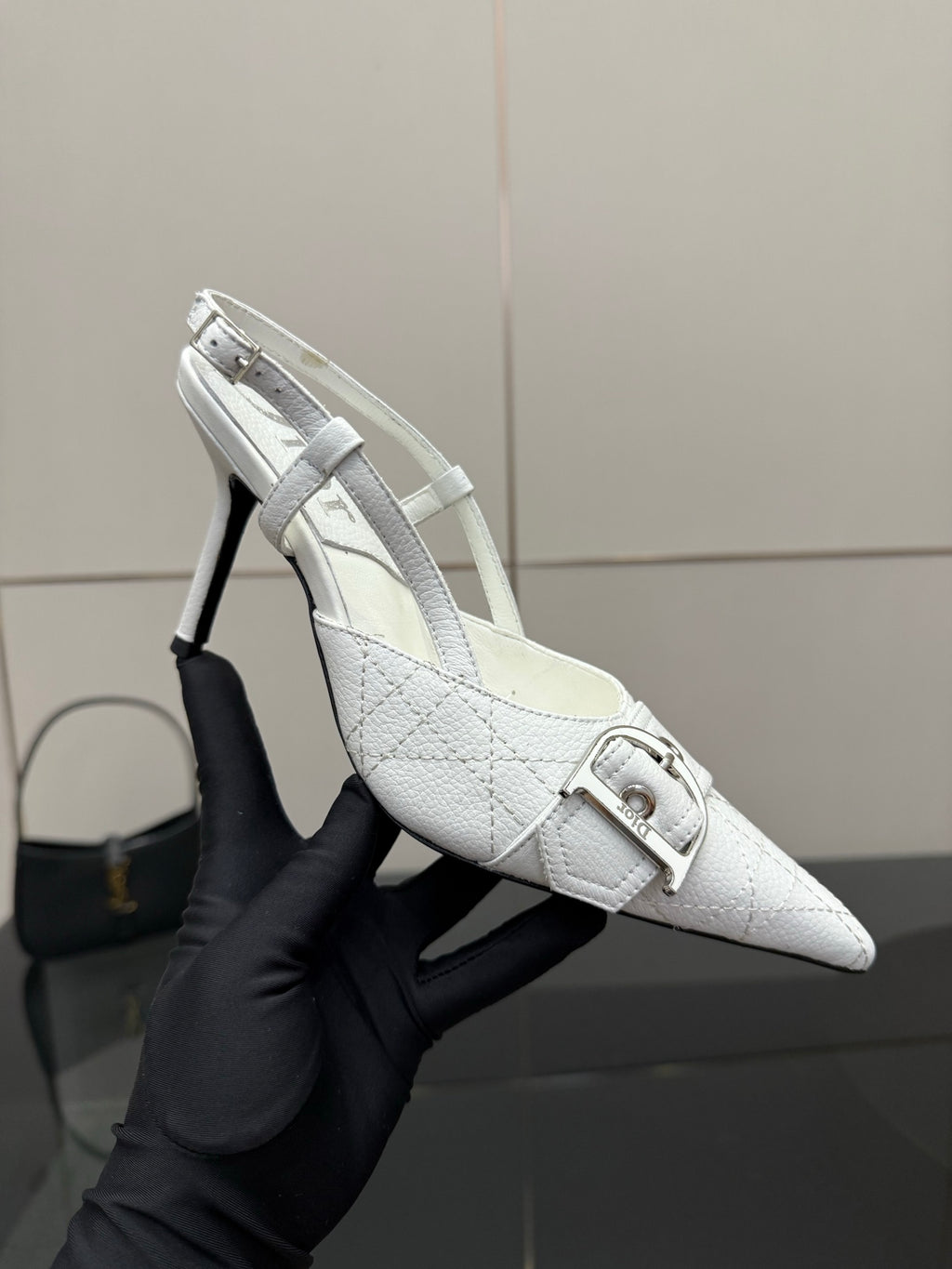 White slingback heel shoe with pointed toe and buckled ankle strap