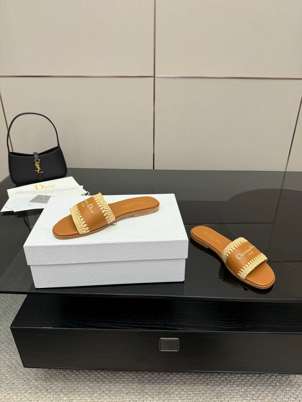 Dior slide sandals with beige braided strap; one on box, one beside it