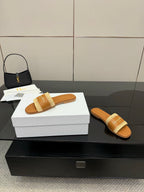 Dior slide sandals with beige braided strap; one on box, one beside it