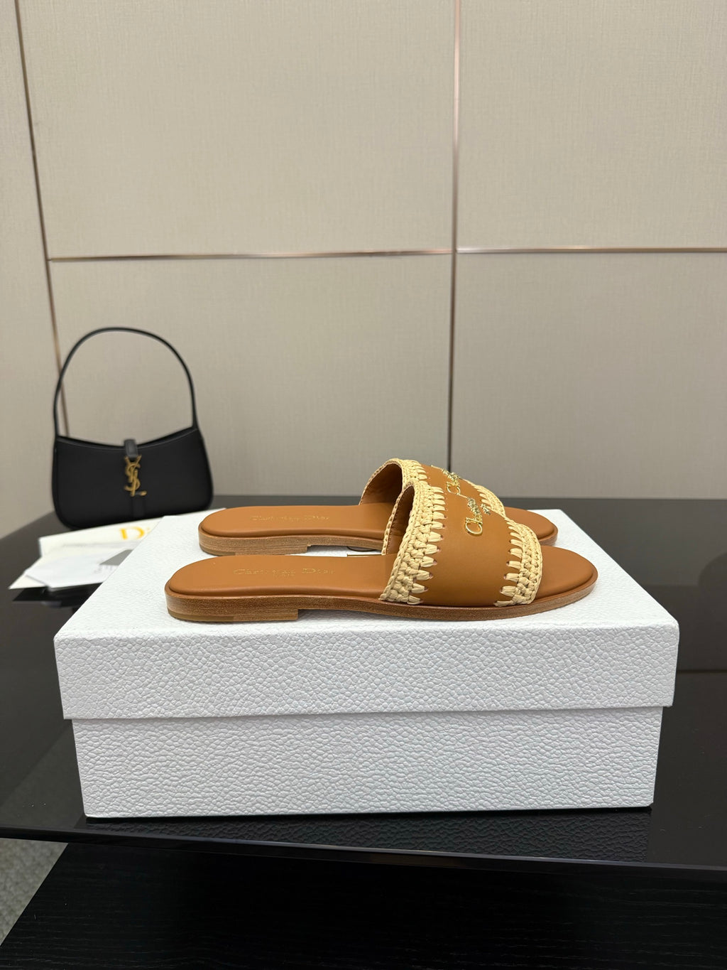 Dior slide sandals with beige braided strap on white shoebox