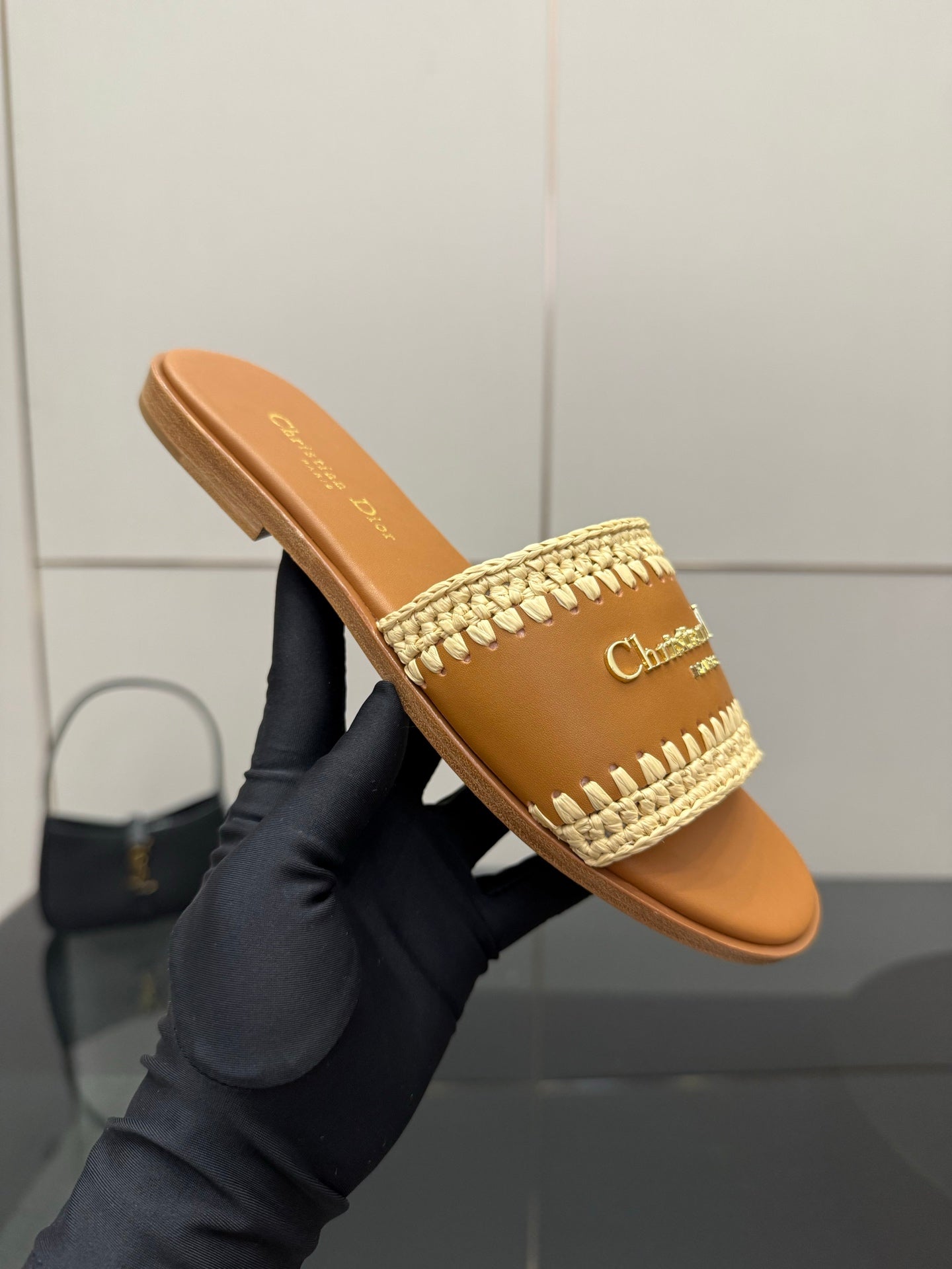 Dior slide sandal on hand, caramel leather with beige braided strap