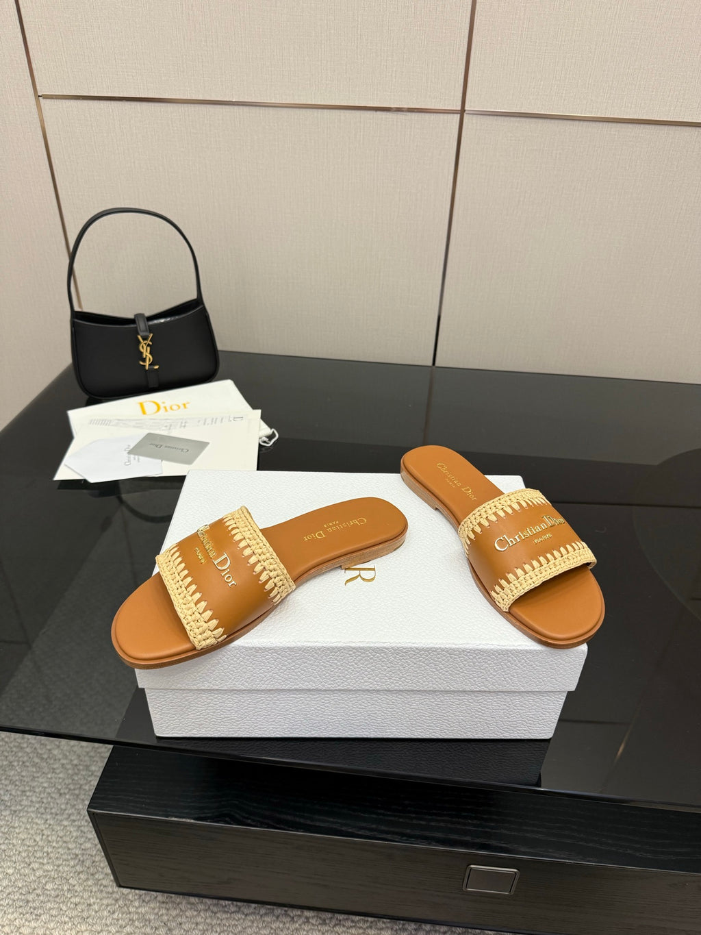 Pair of Dior slide sandals with beige braided straps on white box