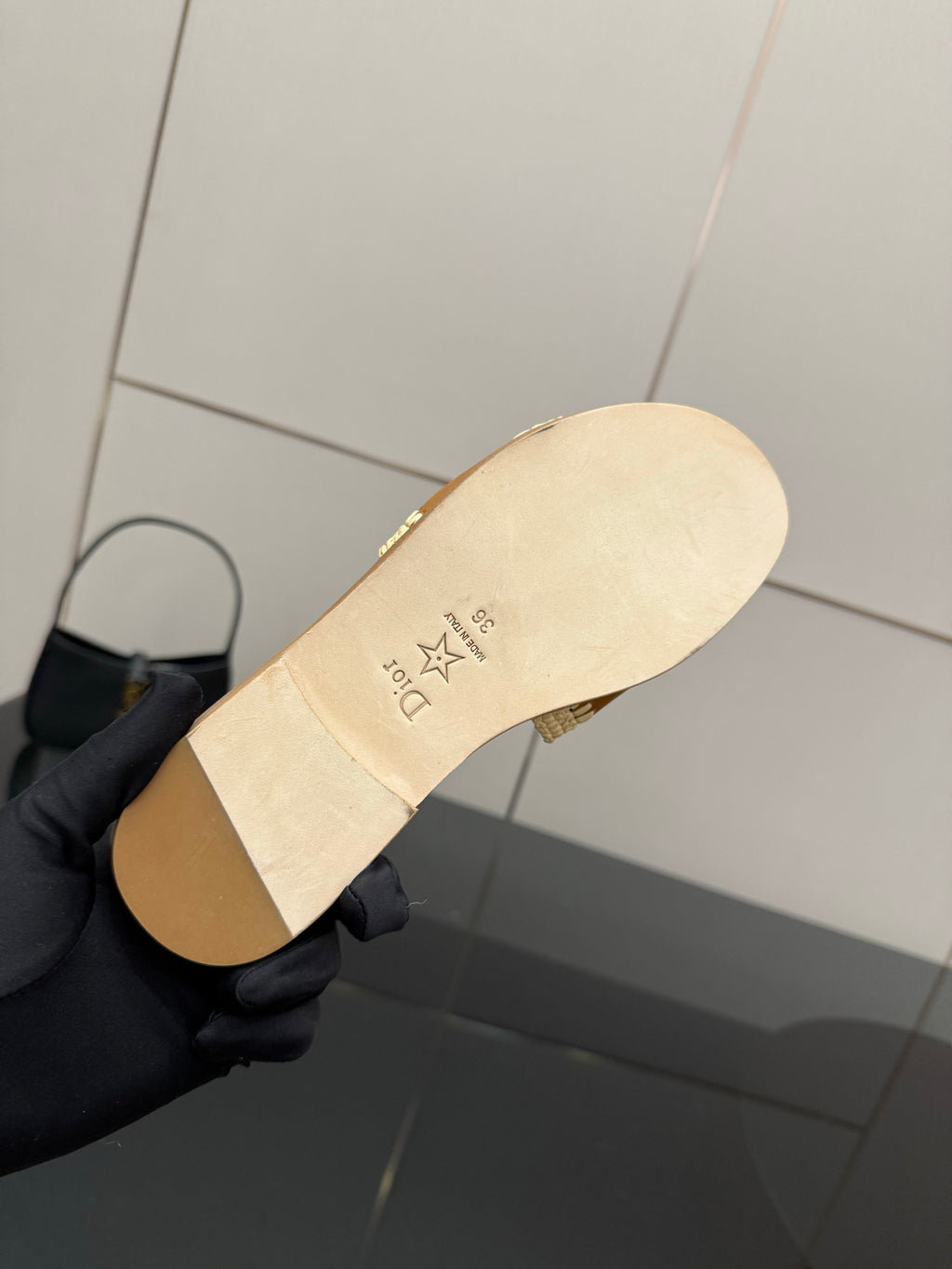 Dior slide sandal outsole view, beige sole with logo text